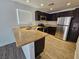 Well-lit kitchen features stainless steel appliances and dark wood cabinetry at 6824 Briarwood Bend Ave, Las Vegas, NV 89130