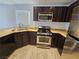 Kitchen features stainless steel appliances, dark wood cabinets and window at 6824 Briarwood Bend Ave, Las Vegas, NV 89130