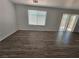 Large living room with abundant natural light and wood-look flooring at 6824 Briarwood Bend Ave, Las Vegas, NV 89130