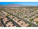 A high-altitude capture of a vibrant residential area, complete with roadways, mountains, and a blue sky at 6868 Sky Pointe Dr # 2035, Las Vegas, NV 89131