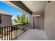 Balcony with metal railing, exterior door, and views of the surrounding neighborhood and greenery at 6868 Sky Pointe Dr # 2035, Las Vegas, NV 89131