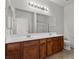 The bathroom showcases a dark wood vanity with dual sinks and large mirrors at 6868 Sky Pointe Dr # 2035, Las Vegas, NV 89131