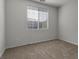 Empty bedroom featuring neutral walls, carpet, and a window offering natural light at 6868 Sky Pointe Dr # 2035, Las Vegas, NV 89131