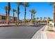 Gated community entrance with lush landscaping, palm trees, and secure access for residents and visitors at 6868 Sky Pointe Dr # 2035, Las Vegas, NV 89131