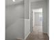 Upstairs hallway featuring a view into a carpeted room with neutral paint and ample light at 6868 Sky Pointe Dr # 2035, Las Vegas, NV 89131