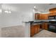 This kitchen features wooden cabinetry, stainless steel appliances, and black granite countertops at 6868 Sky Pointe Dr # 2035, Las Vegas, NV 89131