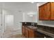 Well-designed kitchen with dark granite counters, raised bar, and stainless steel appliances at 6868 Sky Pointe Dr # 2035, Las Vegas, NV 89131