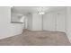 A neutral toned living room features an elegant light fixture and plush carpeting at 6868 Sky Pointe Dr # 2035, Las Vegas, NV 89131