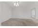A neutral toned living room features an elegant light fixture and plush carpeting at 6868 Sky Pointe Dr # 2035, Las Vegas, NV 89131