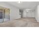 A neutral toned living room with sliding glass door and an elegant light fixture at 6868 Sky Pointe Dr # 2035, Las Vegas, NV 89131