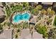 Aerial view of a refreshing community pool surrounded by lush landscaping and lounge chairs for relaxation at 6868 Sky Pointe Dr # 2035, Las Vegas, NV 89131