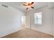 Clean bedroom features neutral carpet, white walls, a ceiling fan, and natural light at 6955 N Durango Dr # 1093, Las Vegas, NV 89149