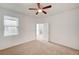 Bright bedroom features neutral carpet, white walls, a ceiling fan, and natural light at 6955 N Durango Dr # 1093, Las Vegas, NV 89149