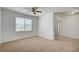 Bright bedroom with a ceiling fan, carpet flooring, and sliding glass door to the balcony at 6955 N Durango Dr # 1093, Las Vegas, NV 89149