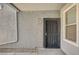 Exterior view of the unit door with a security gate, house number 1093, and a small window nearby at 6955 N Durango Dr # 1093, Las Vegas, NV 89149