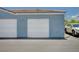Image showcasing a clean, well-maintained garage exterior with a white garage door and a nearby parked car at 6955 N Durango Dr # 1093, Las Vegas, NV 89149