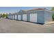 Row of garages featuring white doors, set against a well-maintained exterior, with parking area in front at 6955 N Durango Dr # 1093, Las Vegas, NV 89149