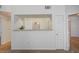 Hallway showing the view of the kitchen, featuring tile flooring and neutral wall color at 6955 N Durango Dr # 1093, Las Vegas, NV 89149
