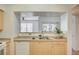 Updated kitchen features stainless sink, white dishwasher and an opening looking into the living area at 6955 N Durango Dr # 1093, Las Vegas, NV 89149