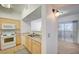 Well-lit kitchen features a modern range, microwave, and stainless steel sink with views through to the living room at 6955 N Durango Dr # 1093, Las Vegas, NV 89149