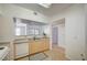 Updated kitchen featuring stainless sink, white dishwasher and an opening looking into the living area at 6955 N Durango Dr # 1093, Las Vegas, NV 89149