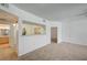 Open living area with a kitchen view, neutral carpet, and easy access to the bathroom at 6955 N Durango Dr # 1093, Las Vegas, NV 89149