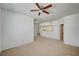 Spacious living room with carpet flooring, natural light, and an open doorway to the kitchen at 6955 N Durango Dr # 1093, Las Vegas, NV 89149