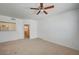 Open-concept living space with neutral carpet, white walls, and view into the bathroom at 6955 N Durango Dr # 1093, Las Vegas, NV 89149