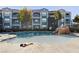 The sparkling swimming pool is surrounded by lush landscaping, offering a serene escape for residents at 6955 N Durango Dr # 1093, Las Vegas, NV 89149