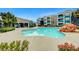 Community pool with surrounding amenities and building in the background at 6955 N Durango Dr # 1093, Las Vegas, NV 89149