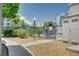 View of the fenced community pool area with surrounding landscaping and partial views of nearby buildings at 6955 N Durango Dr # 1093, Las Vegas, NV 89149