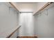 Spacious walk-in closet featuring shelving and wooden closet rods for organization at 6955 N Durango Dr # 1093, Las Vegas, NV 89149