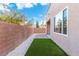 Artificial grass backyard with brick walls and stone landscaping at 7342 Brisbane Hills St, Las Vegas, NV 89166