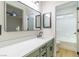 Stylish bathroom featuring green vanity, black fixtures, and a well-lit mirror at 7342 Brisbane Hills St, Las Vegas, NV 89166