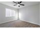 Bedroom featuring neutral colored carpet, a window, and a ceiling fan at 7342 Brisbane Hills St, Las Vegas, NV 89166