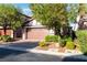 Charming home exterior with a two-car garage and well-maintained landscaping at 7342 Brisbane Hills St, Las Vegas, NV 89166