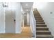 Inviting foyer with wood-look floors, staircase, and modern lighting fixtures at 7342 Brisbane Hills St, Las Vegas, NV 89166