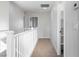 Second floor hallway with white railings and neutral walls and carpet at 7342 Brisbane Hills St, Las Vegas, NV 89166