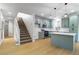 Open floor plan connecting a modern kitchen with an island to the living area at 7342 Brisbane Hills St, Las Vegas, NV 89166