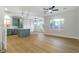Open-concept living room with modern lighting, wood floors, and an island at 7342 Brisbane Hills St, Las Vegas, NV 89166