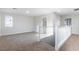 Upstairs loft area with neutral carpet and white railing at 7342 Brisbane Hills St, Las Vegas, NV 89166
