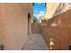 Property sideyard with brick pavers and a stucco wall at 7342 Brisbane Hills St, Las Vegas, NV 89166