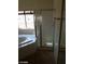Bathroom with a glass-enclosed shower and a soaking tub at 7517 Apple Cider St, Las Vegas, NV 89131