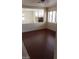 Bright living room with recessed lights, crown molding, dark floors, and a partial fireplace view at 7517 Apple Cider St, Las Vegas, NV 89131