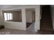 Open-concept living room featuring tile floors, stairway access and natural light at 7517 Apple Cider St, Las Vegas, NV 89131
