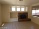 Living room with tile floors, a stone fireplace, built-in shelf and natural light at 7517 Apple Cider St, Las Vegas, NV 89131