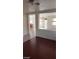 Bright living room with dark floors, and a partial fireplace view at 7517 Apple Cider St, Las Vegas, NV 89131