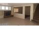 Open living room featuring a stone fireplace and large windows at 7517 Apple Cider St, Las Vegas, NV 89131