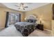 Bedroom with carpet flooring, fan, and balcony with a view of the community at 7701 W Robindale Rd # 274, Las Vegas, NV 89113