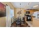 Charming dining area featuring hardwood floors, a glass table, and stylish black metal chairs at 7701 W Robindale Rd # 274, Las Vegas, NV 89113